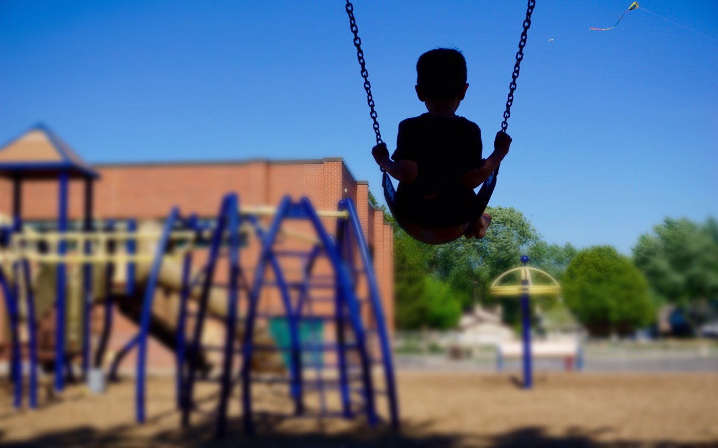boy swinging on swing